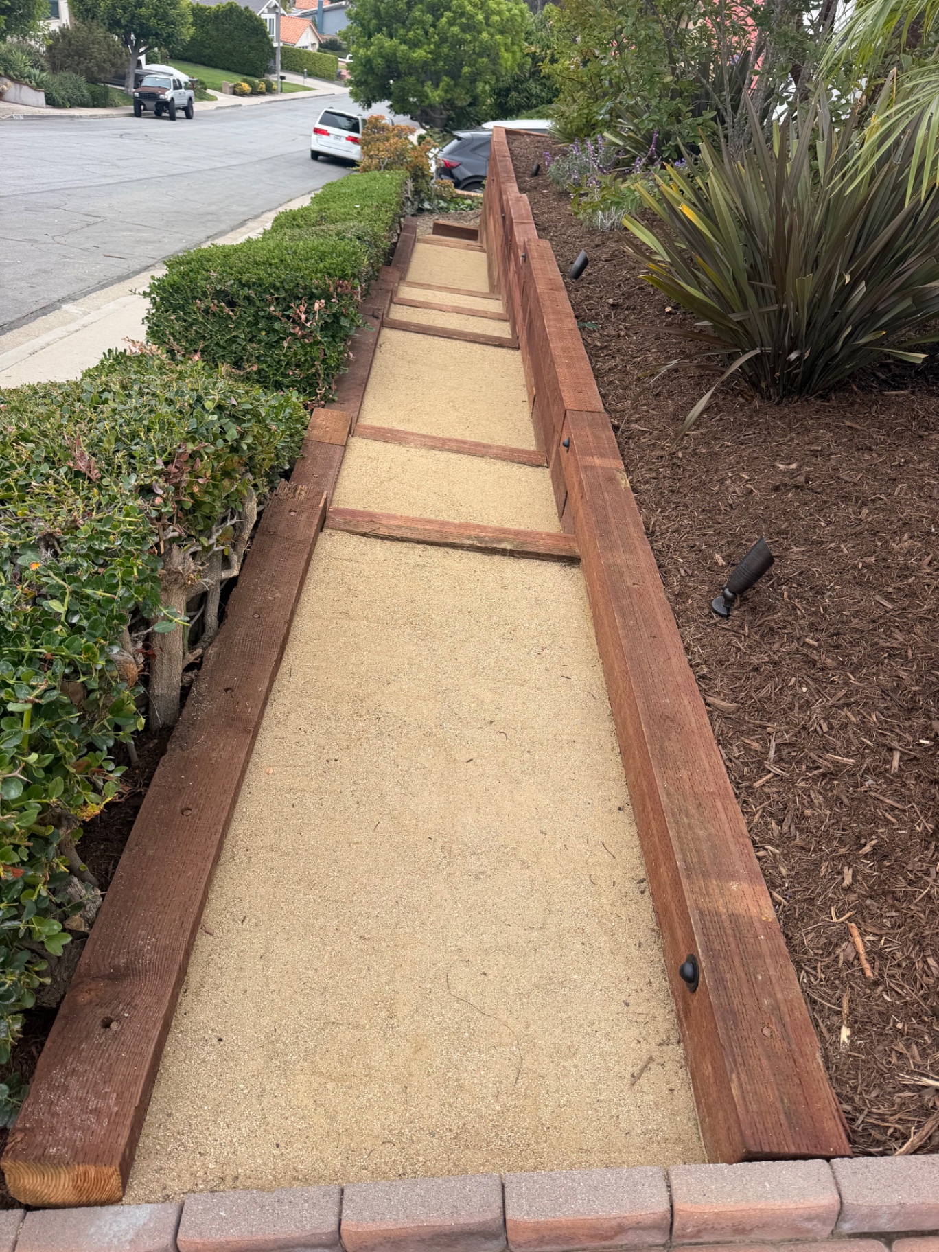Decomposed granite walkway framed with redwood headers